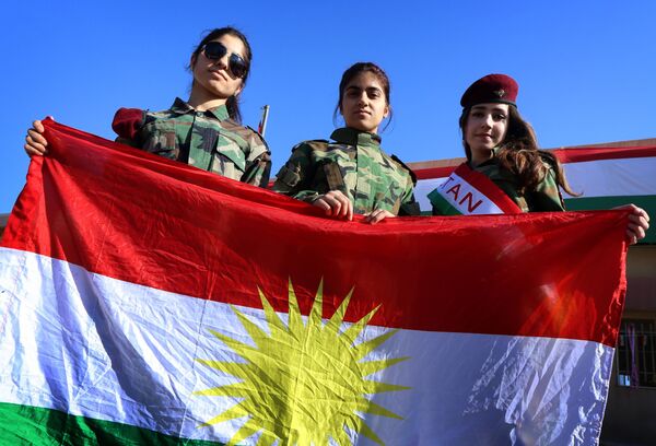 Iraqi Kurdish girls carry a Kurdistan flag during the celebration of Flag Day in the northern city of Arbil, the capital of the autonomous Kurdish region in northern Iraq Iraqi Kurdish girls carry a Kurdistan flag during the celebration of Flag Day in the northern city of Arbil, the capital of the autonomous Kurdish region in northern Iraq - Sputnik International
