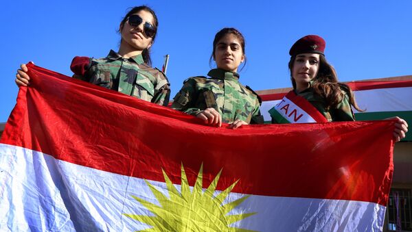 Iraqi Kurdish girls carry a Kurdistan flag during the celebration of Flag Day in the northern city of Arbil, the capital of the autonomous Kurdish region in northern Iraq - Sputnik International