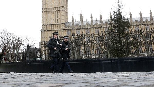 Armed police are seen on patrol at The Houses of Parliament in London, England - Sputnik International
