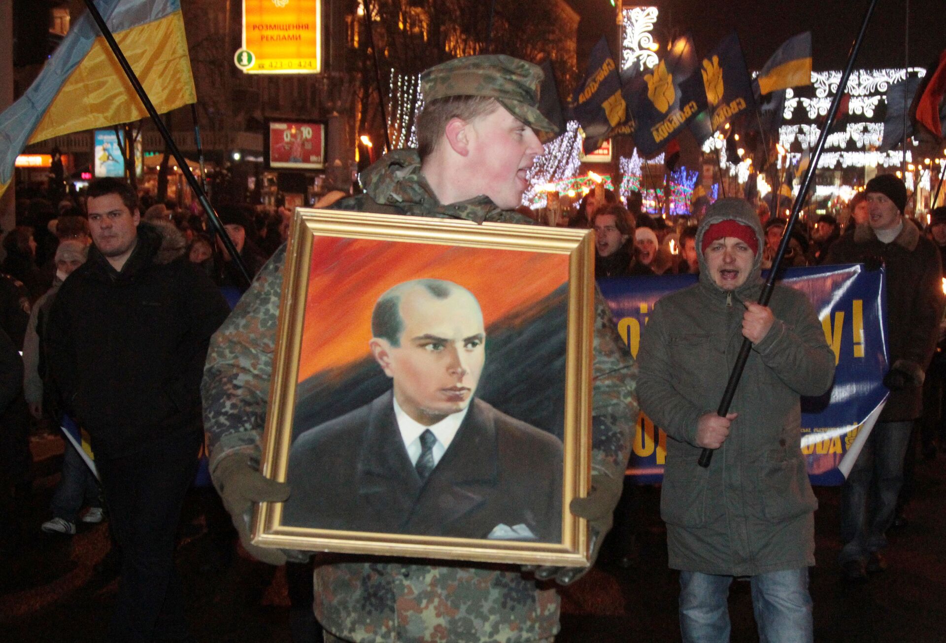 A man carrying a picture of Stepan Bandera during a torchlight procession of Ukrainian nationalists in downtown Kiev. File photo  - Sputnik International, 1920, 03.03.2022