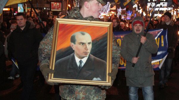 A man carrying a picture of Stepan Bandera during a torchlight procession of Ukrainian nationalists in downtown Kiev. File photo - Sputnik International