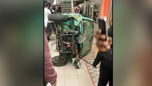Cell phone shot of the remains of a car pushed down subway station cars by teenagers in Brussels. - Sputnik International