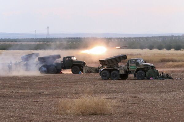 In this photo taken on Wednesday, Oct. 7, 2015, Syrian army rocket launchers fire near the village of Morek in Syria In this photo taken on Wednesday, Oct. 7, 2015, Syrian army rocket launchers fire near the village of Morek in Syria - Sputnik International