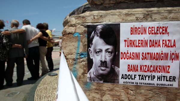 A depiction of Turkish Prime Minister Recep Tayyip Erdogan portraying him as Nazi leader Adolf Hitler is pasted on the front of Mustafa Kemal Ataturk's statue, founder of Turkey, at the Taksim square in Istanbul on Thursday, June 6, 2013 - Sputnik International