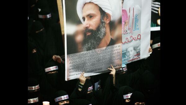 FILE - In this Sunday, Sept. 30, 2012 file photo, a Saudi anti-government protester carries a poster with the image of jailed Shiite cleric Sheik Nimr al-Nimr during the funeral of three Shiite Muslims allegedly killed by Saudi security forces in the eastern town of al-Awamiya, Saudi Arabia - Sputnik International