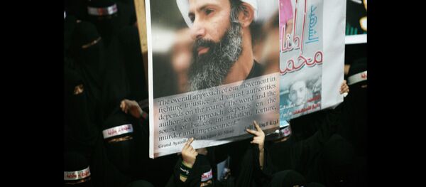FILE - In this Sunday, Sept. 30, 2012 file photo, a Saudi anti-government protester carries a poster with the image of jailed Shiite cleric Sheik Nimr al-Nimr during the funeral of three Shiite Muslims allegedly killed by Saudi security forces in the eastern town of al-Awamiya, Saudi Arabia - Sputnik International