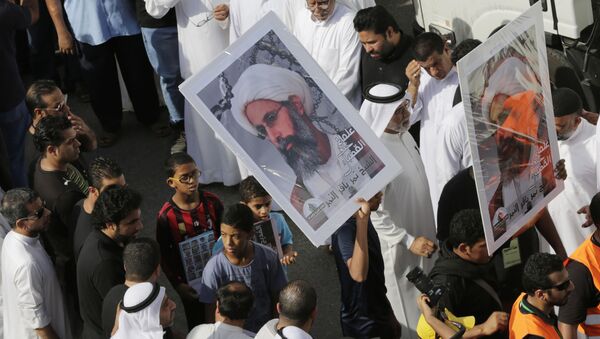 In this Saturday, May 30, 2015, photo, Saudis carry a poster demanding freedom for jailed Shiite cleric Sheikh Nimr al-Nimr, during a funeral procession, in Tarut, Saudi Arabia - Sputnik International