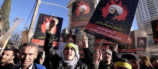 Iranian protesters chant slogans as they hold pictures of Shi'ite cleric Sheikh Nimr al-Nimr during a demonstration against the execution of Nimr in Saudi Arabia, outside the Saudi Arabian Embassy in Tehran January, 3, 2016 Iranian protesters chant slogans as they hold pictures of Shi'ite cleric Sheikh Nimr al-Nimr during a demonstration against the execution of Nimr in Saudi Arabia, outside the Saudi Arabian Embassy in Tehran January, 3, 2016 - Sputnik International
