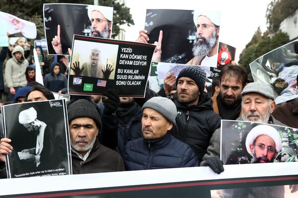 Iranian and Turkish demonstrators hold pictures of Shiite cleric Sheikh Nimr al-Nimr as they protest outside the Saudi Embassy in Ankara, on January 3, 2016, to protest against the execution by Saudi Arabia of a prominent Shiite cleric which they saw as a deliberate sectarian aggression Iranian and Turkish demonstrators hold pictures of Shiite cleric Sheikh Nimr al-Nimr as they protest outside the Saudi Embassy in Ankara, on January 3, 2016, to protest against the execution by Saudi Arabia of a prominent Shiite cleric which they saw as a deliberate sectarian aggression - Sputnik International