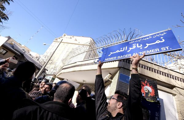 An Iranian protester holds up a street sign with the name of Shi'ite cleric Sheikh Nimr al-Nimr during a demonstration against the execution of Nimr in Saudi Arabia, outside the Saudi Arabian Embassy in Tehran January, 3, 2016 An Iranian protester holds up a street sign with the name of Shi'ite cleric Sheikh Nimr al-Nimr during a demonstration against the execution of Nimr in Saudi Arabia, outside the Saudi Arabian Embassy in Tehran January, 3, 2016 - Sputnik International