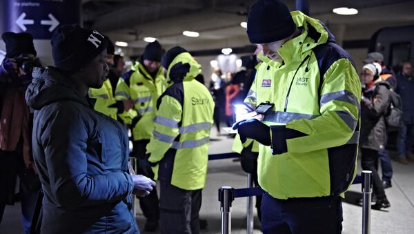 A passenger has her ID checked at the train station Copenhagen International Airport in Kastrup to prevent illegal migrants entering Sweden on Monday Jan. 4, 2016 - Sputnik International