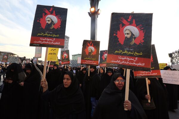 Iranian women gather during a demonstration against the execution of prominent Shiite Muslim cleric Nimr al-Nimr (portrait) by Saudi authorities, at Imam Hossein Square in the capital Tehran on January 4, 2016 Iranian women gather during a demonstration against the execution of prominent Shiite Muslim cleric Nimr al-Nimr (portrait) by Saudi authorities, at Imam Hossein Square in the capital Tehran on January 4, 2016 - Sputnik International