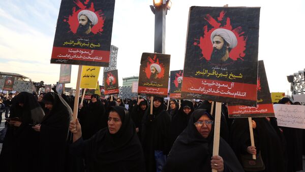 Iranian women gather during a demonstration against the execution of prominent Shiite Muslim cleric Nimr al-Nimr (portrait) by Saudi authorities, at Imam Hossein Square in the capital Tehran on January 4, 2016 - Sputnik International
