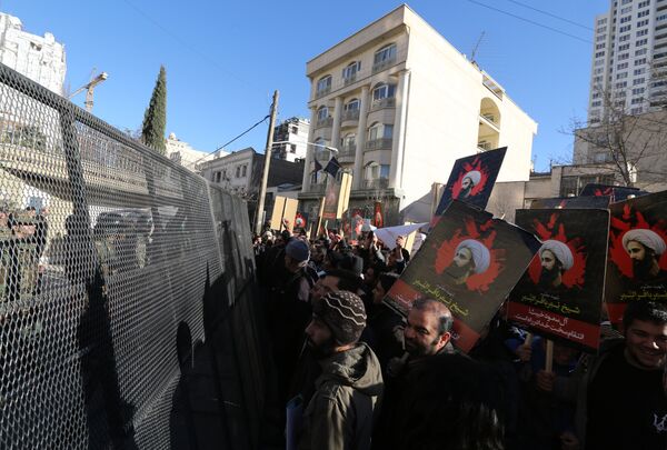 Iranian riot police block a street leading to the Saudi embassy as protesters hold portraits of prominent Shiite Muslim cleric Nimr al-Nimr during a demonstration against his execution by Saudi authorities, on January 3, 2016, in Tehran Iranian riot police block a street leading to the Saudi embassy as protesters hold portraits of prominent Shiite Muslim cleric Nimr al-Nimr during a demonstration against his execution by Saudi authorities, on January 3, 2016, in Tehran - Sputnik International