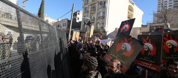Iranian riot police block a street leading to the Saudi embassy as protesters hold portraits of prominent Shiite Muslim cleric Nimr al-Nimr during a demonstration against his execution by Saudi authorities, on January 3, 2016, in Tehran Iranian riot police block a street leading to the Saudi embassy as protesters hold portraits of prominent Shiite Muslim cleric Nimr al-Nimr during a demonstration against his execution by Saudi authorities, on January 3, 2016, in Tehran - Sputnik International