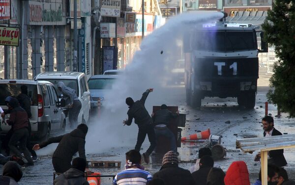 Riot police use a water cannon to disperse stone throwing Kurdish demonstrators during a protest against the curfew in Sur district, in the southeastern city of Diyarbakir, Turkey, December 22, 2015 Riot police use a water cannon to disperse stone throwing Kurdish demonstrators during a protest against the curfew in Sur district, in the southeastern city of Diyarbakir, Turkey, December 22, 2015 - Sputnik International