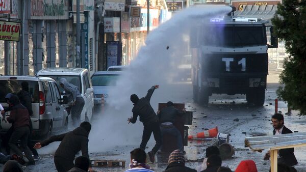 Riot police use a water cannon to disperse stone throwing Kurdish demonstrators during a protest against the curfew in Sur district, in the southeastern city of Diyarbakir, Turkey, December 22, 2015 - Sputnik International
