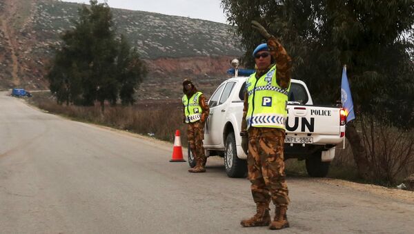Police members of U.N. peacekeepers of the United Nations Interim Force in Lebanon (UNIFIL) patrol along a road in Marjayoun plain near the Lebanese-Israeli border, southern Lebanon, January 4, 2016 - Sputnik International