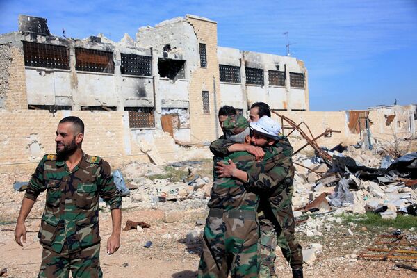Syrian government troops hug each other in celebration inside the Kuweires air base, east of Aleppo, Syria Syrian government troops hug each other in celebration inside the Kuweires air base, east of Aleppo, Syria - Sputnik International
