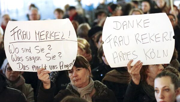 Women hold up placards that read Mrs. Merkel: Where are you? What are you saying? This worries us! and Thanks (Cologne mayor Henriette) Reker!! Poor Cologne (R) during a protest in front of the Cologne Cathedral, Germany, January 5, 2016 - Sputnik International