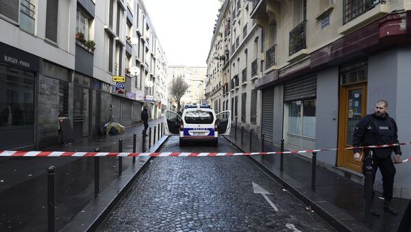 French police are seen behind a police cordon at the Rue des Islettes near Barbes-Rochechouart metro station in the north of Paris on January 7, 2016, after police shot a man dead as he was trying to enter a police station - Sputnik International