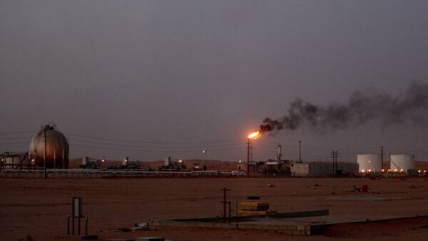 A flame from a Saudi Aramco (the national oil company) oil installation known as Pump 3 burns brightly during sunset in the Saudi Arabian desert near the oil-rich area Al-Khurais, 160 kms east of the capital Riyadh - Sputnik International