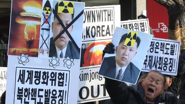 A South Korean protester with a photo of North Korean leader Kim Jong Un shouts slogans during a rally against North Korea's announcement that it had tested a hydrogen bomb. - Sputnik International