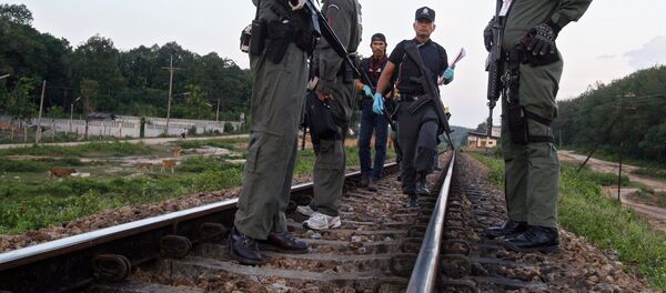 Thai police officers look for evidence on rail tracks in Thailand Thai police officers look for evidence on rail tracks in Thailand - Sputnik International