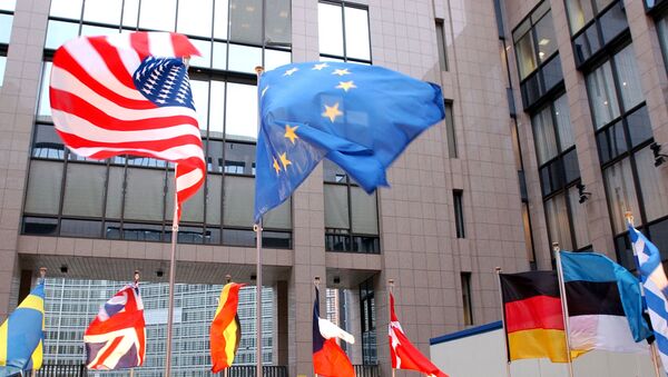The US and EU flags, top left and right, fly in separate directions at the European Council building in Brussels - Sputnik International