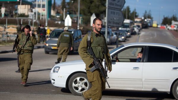 Israeli soldiers stand guard at the Gush Etzion junction in the Israeli occupied West Bank on the main road between Jerusalem and Hebron on January 5, 2016 - Sputnik International