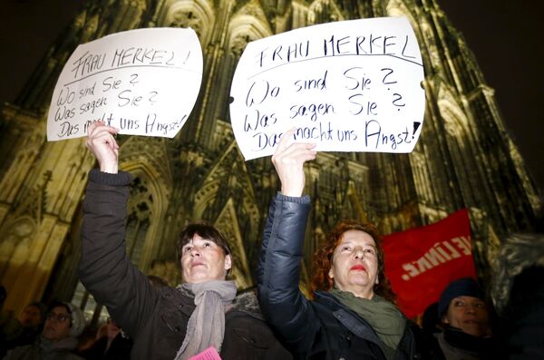 Women hold up placards that read Mrs. Merkel: Where are you? What are you saying? This worries us! during a protest in front of the Cologne Cathedral, Germany, January 5, 2016. Germans have been deeply shocked by a series of attacks, assaults, and other crimes committed by asylum-seekers taking advantage of Merkel's open-door immigration policy. Women hold up placards that read Mrs. Merkel: Where are you? What are you saying? This worries us! during a protest in front of the Cologne Cathedral, Germany, January 5, 2016. Germans have been deeply shocked by a series of attacks, assaults, and other crimes committed by asylum-seekers taking advantage of Merkel's open-door immigration policy. - Sputnik International