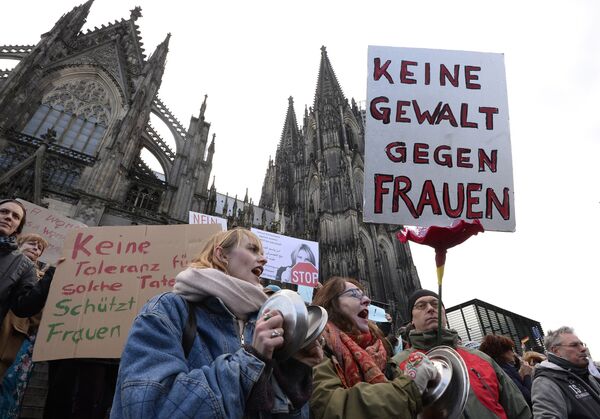 A man holds up a sign reading No violence against women as he takes part in a demonstration in front of the cathedral in Cologne, western Germany, on January 9, 2015 where sexual assaults in a crowd of migrants took place on New Year's Eve A man holds up a sign reading No violence against women as he takes part in a demonstration in front of the cathedral in Cologne, western Germany, on January 9, 2015 where sexual assaults in a crowd of migrants took place on New Year's Eve - Sputnik International