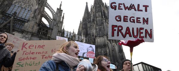 A man holds up a sign reading No violence against women as he takes part in a demonstration in front of the cathedral in Cologne, western Germany, on January 9, 2015 where sexual assaults in a crowd of migrants took place on New Year's Eve A man holds up a sign reading No violence against women as he takes part in a demonstration in front of the cathedral in Cologne, western Germany, on January 9, 2015 where sexual assaults in a crowd of migrants took place on New Year's Eve - Sputnik International