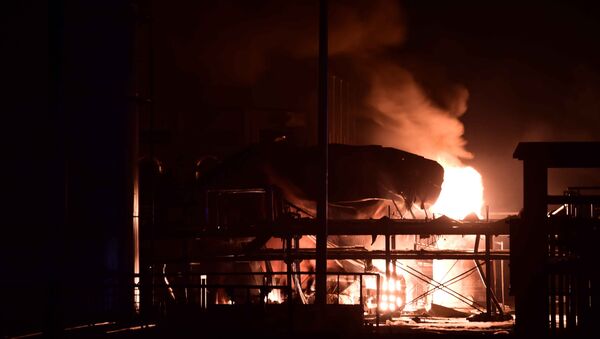 In this photo released by China's Xinhua News Agency, a chemical plant of Shandong Runxing Chemical Technology Co. is on fire following an explosion in Zibo, east China's Shandong Province, Sunday, Aug. 23, 2015 - Sputnik International