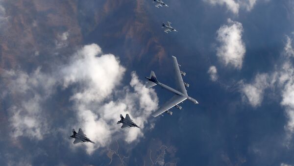 This picture taken by the Republic of Korea Air Force on January 10, 2016 and released via Yonhap news agency shows a US B-52 Stratofortress (C) flying with South Korean F-15K fighter jets (bottom) and US F-16 fighter jets (top) over South Korea - Sputnik International