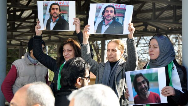 Women hold pictures of film maker Naji Jerf, who was killed on December 27, during his funeral in Gaziantep on December 28, 2015 - Sputnik International