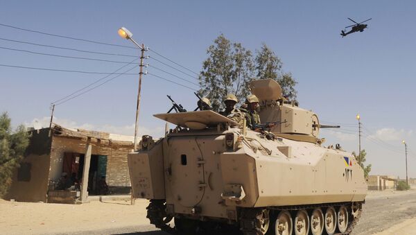 File photo, Egyptian Army soldiers patrol in an armored vehicle backed by a helicopter gunship during a sweep through villages in Sheikh Zuweyid, north Sinai, Egypt - Sputnik International
