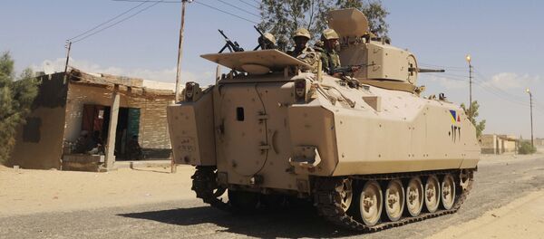 File photo, Egyptian Army soldiers patrol in an armored vehicle backed by a helicopter gunship during a sweep through villages in Sheikh Zuweyid, north Sinai, Egypt - Sputnik International