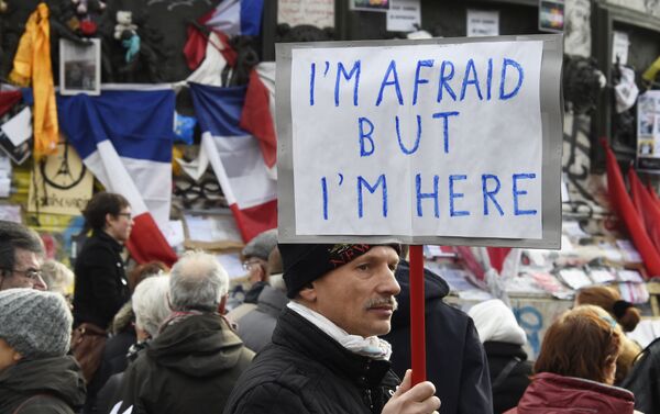 A man holding a placard reading I am afraid but I am here during a gathering on Place de la Republique (Republic square) on January 10, 2016 in Paris, as the city marks a year since 1.6 million people thronged the French capital in a show of unity after attacks on the Charlie Hebdo newspaper and a Jewish supermarket - Sputnik International