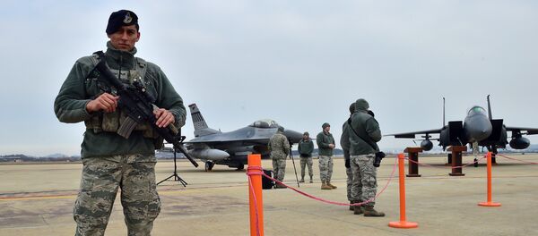 A US soldier (L) stands guard near a US F-16 fighter jet (C) and a South Korea F-15K fighter jet (R) before a press briefing on the flight by a US B-52 Stratofortress over South Korea at the Osan Air Base in Pyeongtaek, south of Seoul, on January 10, 2016 A US soldier (L) stands guard near a US F-16 fighter jet (C) and a South Korea F-15K fighter jet (R) before a press briefing on the flight by a US B-52 Stratofortress over South Korea at the Osan Air Base in Pyeongtaek, south of Seoul, on January 10, 2016 - Sputnik International