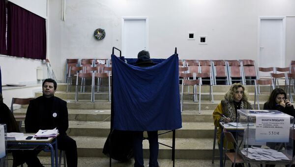 A man prepares his vote in a voting booth prior to casting his ballot in an election for the leadership of Greece's conservative New Democracy party, at a polling station in Athens on January 10, 2016 - Sputnik International