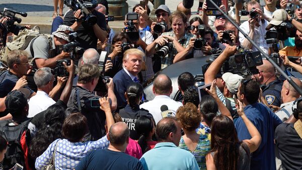 US presidential candidate Donald Trump(C) is mobbed by the media as he exits New York Supreme Court after morning jury duty August 17, 2015 in New York - Sputnik International