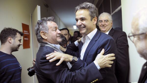 Kyriakos Mitsotakis (c-R), the new elected leader of Greece's conservative New Democracy party, hugs a supporter during his exit from his office in Athens, after winning the party elections, Greece, January 11, 2016 - Sputnik International