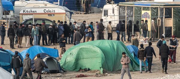 People walk at the migrant camp known as the Jungle in Calais on December 7, 2015 - Sputnik International