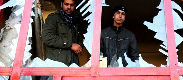 In this Monday, Dec. 28, 2015, file photo, an Afghan shopkeeper watches from the broken window of his shop near the site of suicide car bomb attack in Kabul, Afghanistan. In this Monday, Dec. 28, 2015, file photo, an Afghan shopkeeper watches from the broken window of his shop near the site of suicide car bomb attack in Kabul, Afghanistan. - Sputnik International