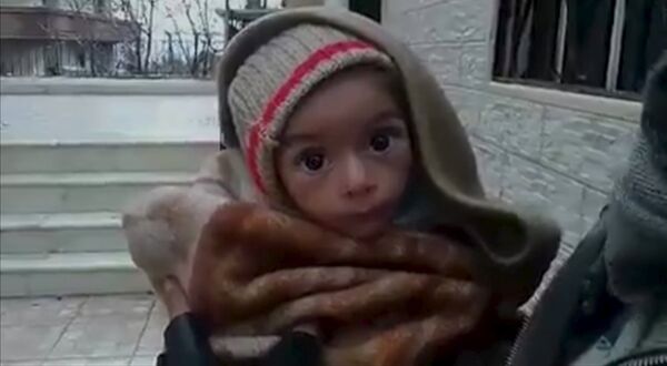 A toddler is held up to the camera in this still image taken from video said to be shot in Madaya on January 5, 2016 A toddler is held up to the camera in this still image taken from video said to be shot in Madaya on January 5, 2016 - Sputnik International