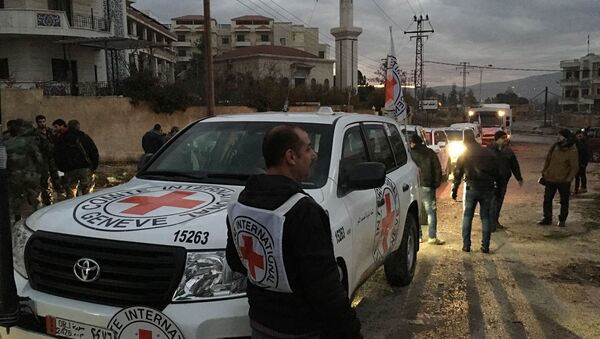This picture provided by The International Committee of the Red Cross (ICRC), working alongside the Syrian Arab Red Crescent (SARC) and the United Nations (UN), shows a convoy containing food, medical items, blankets and other materials being delivered to the town of Madaya in Syria, Monday, Jan. 11, 2016 - Sputnik International