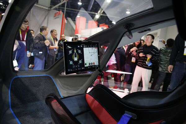 People crowd around the EHang 184 autonomous aerial vehicle at the EHang booth at CES International, Wednesday, Jan. 6, 2016, in Las Vegas People crowd around the EHang 184 autonomous aerial vehicle at the EHang booth at CES International, Wednesday, Jan. 6, 2016, in Las Vegas - Sputnik International