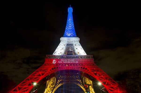 A photo taken on November 17, 2015 in Paris shows the Eiffel Tower illuminated with the colors of the French national flag in tribute to the victims of the November 13 Paris terror attacks. A photo taken on November 17, 2015 in Paris shows the Eiffel Tower illuminated with the colors of the French national flag in tribute to the victims of the November 13 Paris terror attacks. - Sputnik International