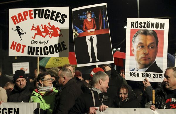 Members of LEGIDA, the Leipzig arm of the anti-Islam movement Patriotic Europeans Against the Islamisation of the West (PEGIDA), take part in a rally in Leipzig, Germany January 11, 2016. Members of LEGIDA, the Leipzig arm of the anti-Islam movement Patriotic Europeans Against the Islamisation of the West (PEGIDA), take part in a rally in Leipzig, Germany January 11, 2016. - Sputnik International